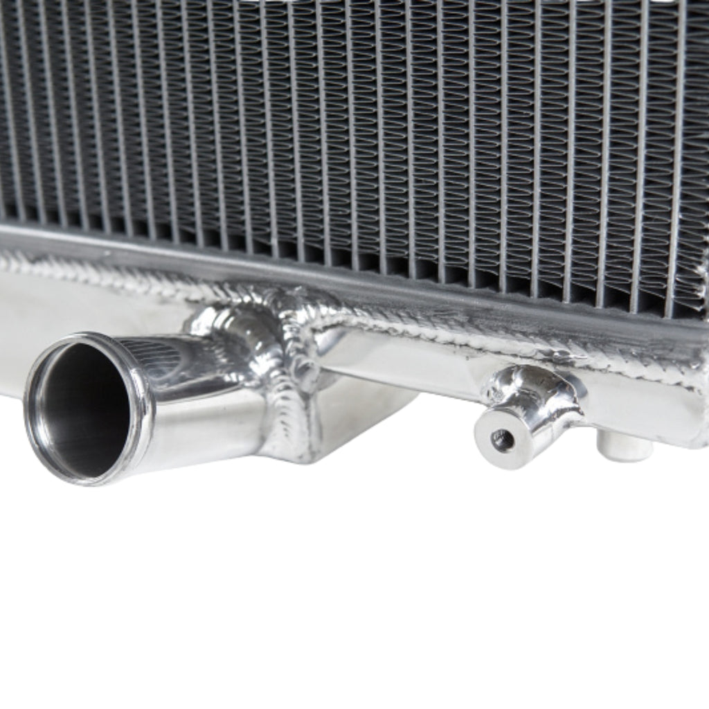 Close-up of a metallic radiator with pipes on a white background