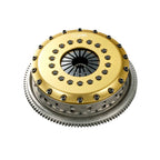 OS Giken Clutch disc with gold and silver metallic finish on a white background