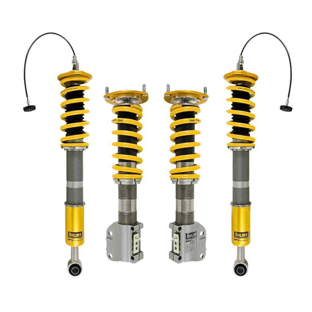 Four Ohlins shock absorber coilovers with yellow springs on a white background